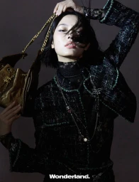 Behind the screen, she rises