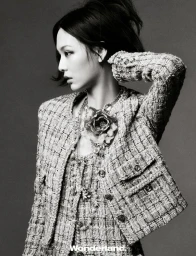 Behind the screen, she rises