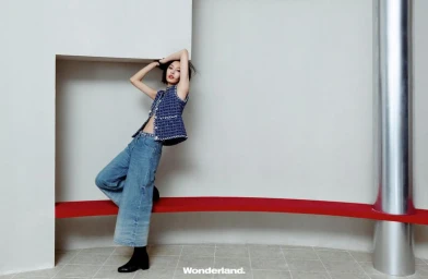 Behind the screen, she rises