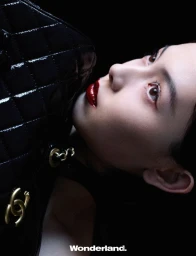 Behind the screen, she rises