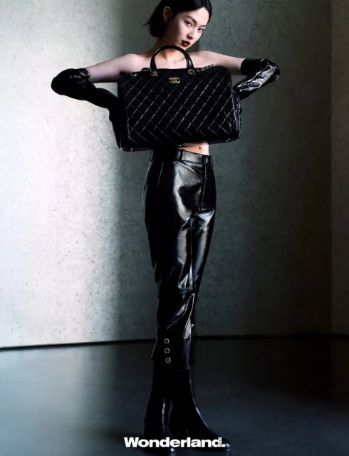 Behind the screen, she rises